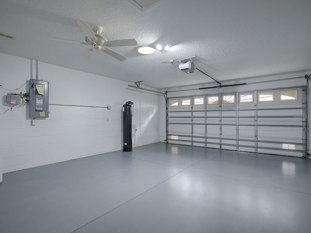 garage with electric panel, a garage door opener, ceiling fan, and water heater