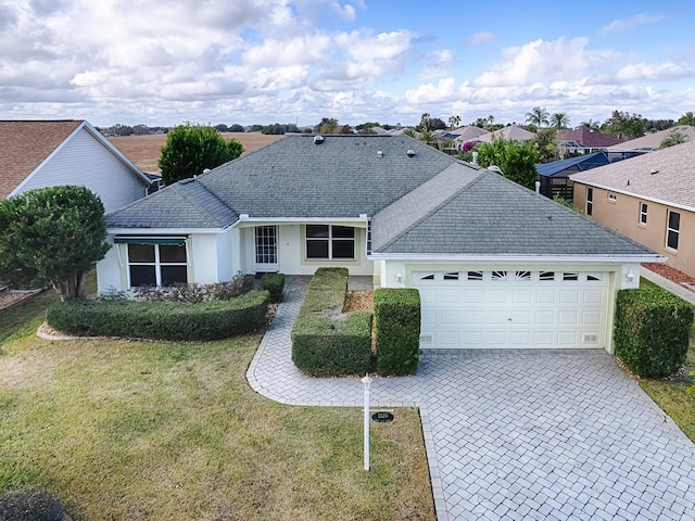 ranch-style home with a front yard and a garage