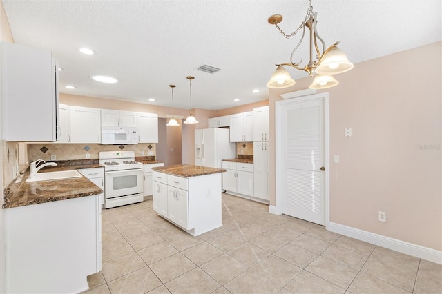 kitchen featuring pendant lighting, white appliances, sink, a kitchen island, and white cabinetry