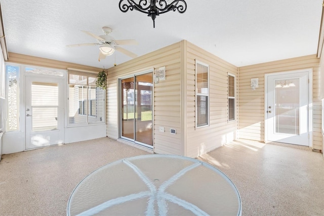 sunroom / solarium featuring ceiling fan