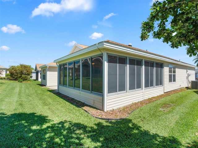 view of property exterior with a yard, cooling unit, and a sunroom