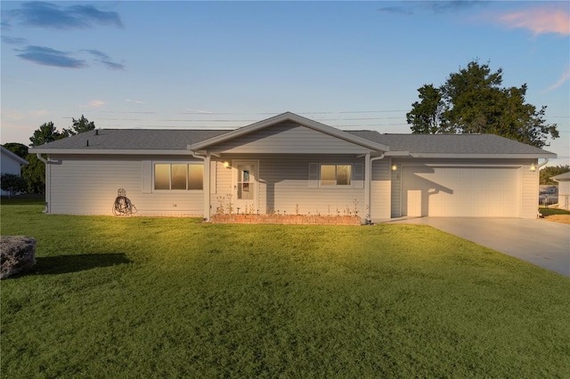 ranch-style house featuring a lawn and a garage