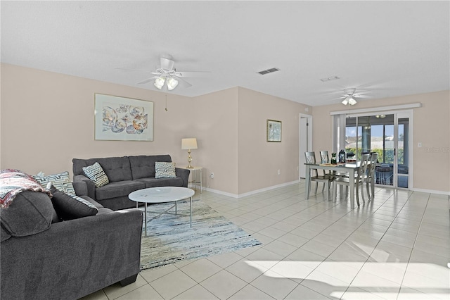 living room featuring ceiling fan and light tile patterned flooring