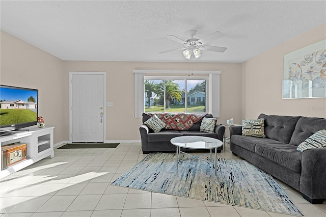 living room featuring light tile patterned floors, a textured ceiling, and ceiling fan