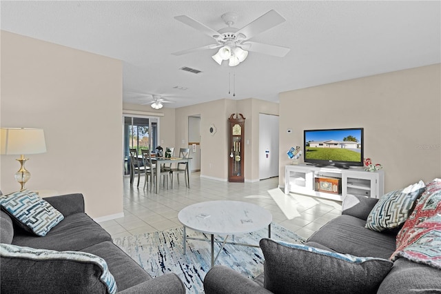 living room with ceiling fan and light tile patterned floors