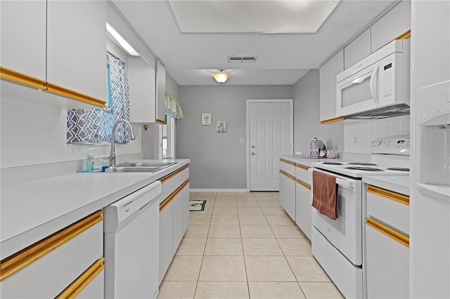 kitchen featuring white cabinetry, sink, light tile patterned floors, and white appliances