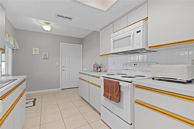 kitchen featuring white cabinets, decorative backsplash, white appliances, and light tile patterned floors