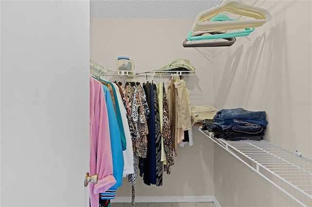 walk in closet featuring tile patterned flooring