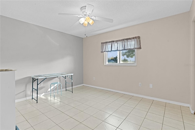 tiled spare room with ceiling fan and a textured ceiling