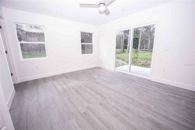 empty room featuring ceiling fan and hardwood / wood-style floors