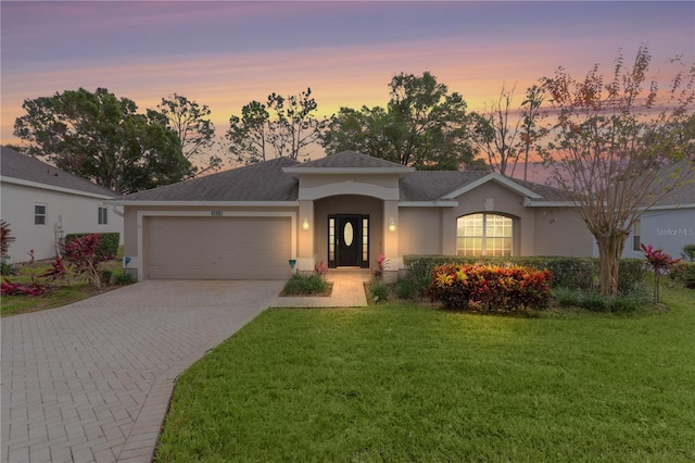 view of front facade featuring a lawn and a garage