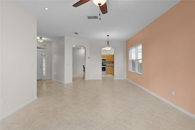 unfurnished living room featuring ceiling fan and light tile patterned flooring