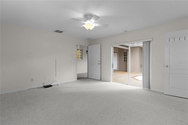 unfurnished bedroom with ceiling fan and light colored carpet