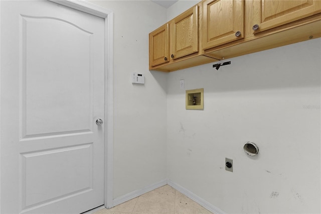 laundry area with electric dryer hookup, cabinets, light tile patterned floors, and hookup for a washing machine