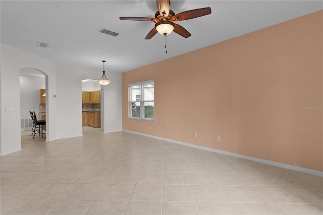 tiled spare room featuring ceiling fan