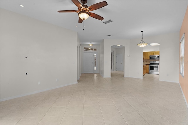 unfurnished living room with ceiling fan and light tile patterned flooring