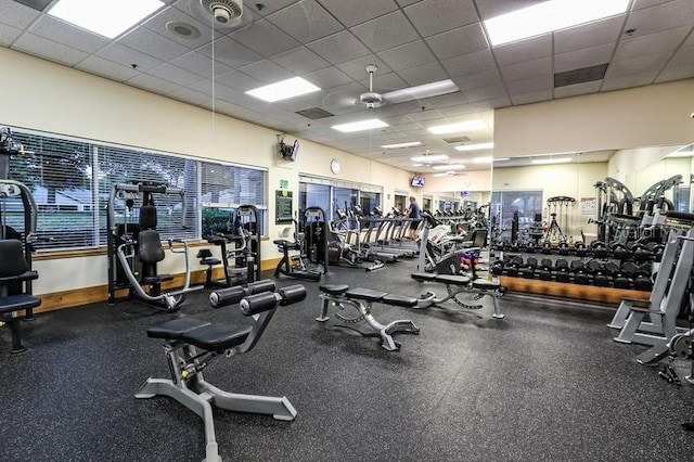 workout area featuring a paneled ceiling and ceiling fan