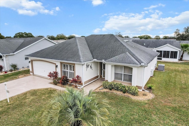 ranch-style house featuring a front lawn, cooling unit, and a garage