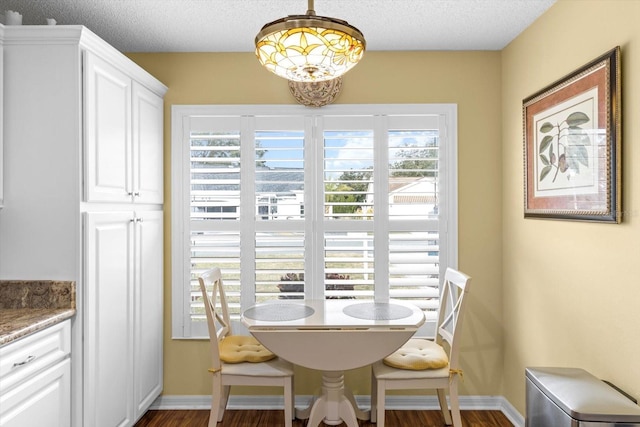 dining area featuring a textured ceiling and breakfast area