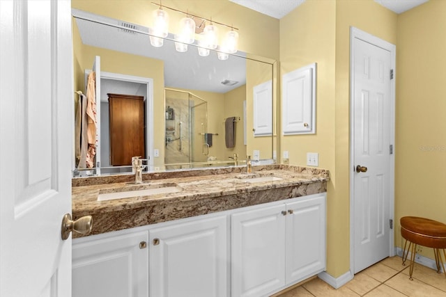 bathroom featuring vanity, a shower with door, and tile patterned floors