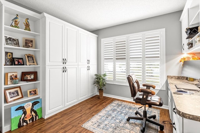 home office featuring a textured ceiling and dark hardwood / wood-style floors