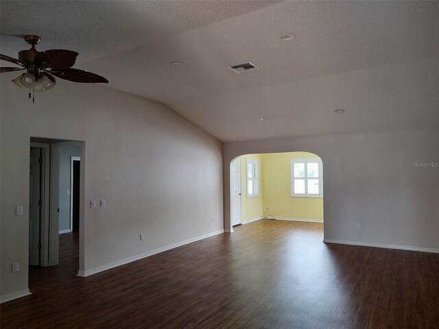 603 San Pedro Dr, The Villages, FL 32159 - spare room featuring arched walkways, a ceiling fan, lofted ceiling, dark wood finished floors, and baseboards
