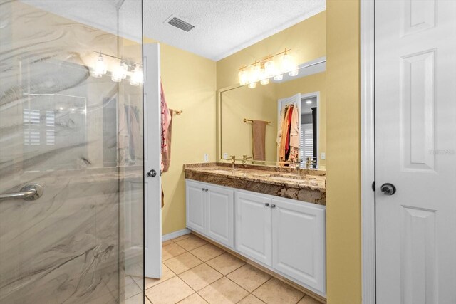 603 San Pedro Dr, The Villages, FL 32159 - full bathroom with a marble finish shower, tile patterned flooring, double vanity, and a textured ceiling