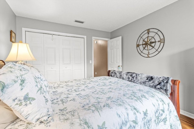 603 San Pedro Dr, The Villages, FL 32159 - bedroom with a closet, wood finished floors, and baseboards