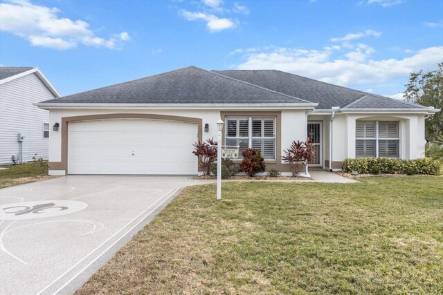 603 San Pedro Dr, The Villages, FL 32159 - single story home with stucco siding, an attached garage, concrete driveway, roof with shingles, and a front lawn