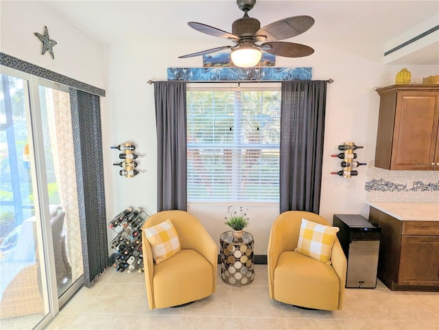 sitting room featuring ceiling fan and light tile patterned floors