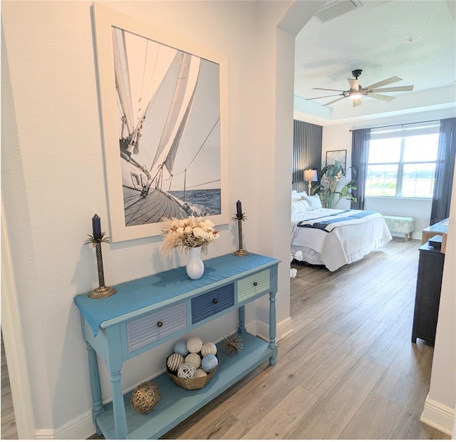 bedroom with wood-type flooring and ceiling fan