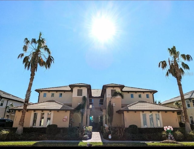 view of front of home with stucco siding and a tiled roof