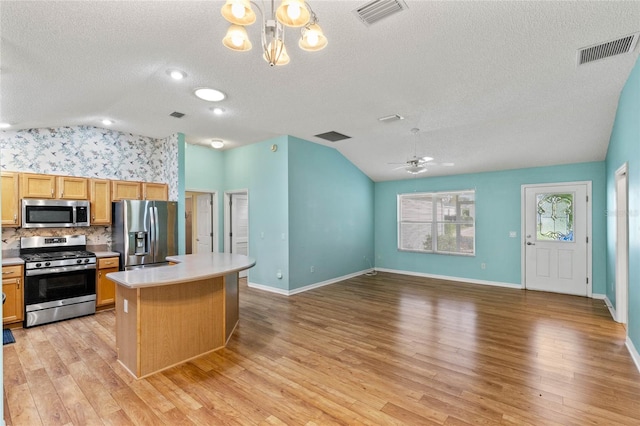 kitchen featuring visible vents, appliances with stainless steel finishes, and vaulted ceiling