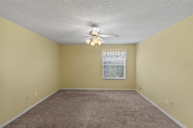 carpeted spare room with ceiling fan, baseboards, and a textured ceiling