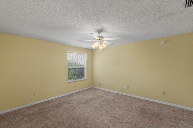 spare room featuring baseboards, visible vents, ceiling fan, a textured ceiling, and carpet flooring