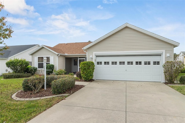 ranch-style house with concrete driveway and an attached garage