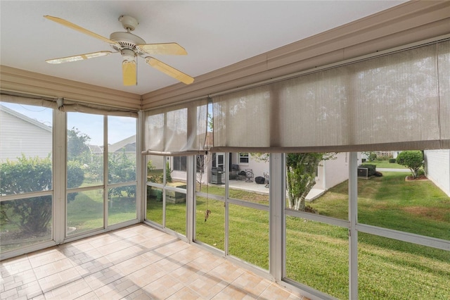 unfurnished sunroom featuring a ceiling fan