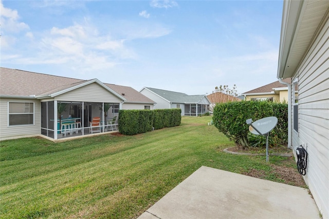 view of yard featuring a sunroom and a patio area