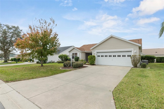 ranch-style home featuring an attached garage, concrete driveway, and a front yard