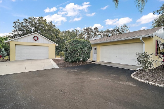 view of front of home featuring a garage and an outdoor structure