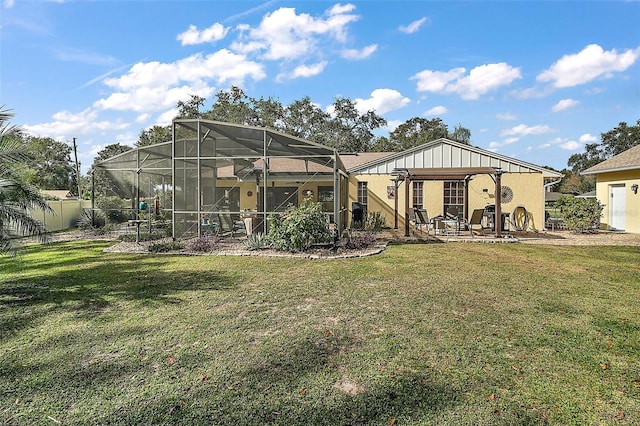 back of house featuring a lanai, a yard, and a patio