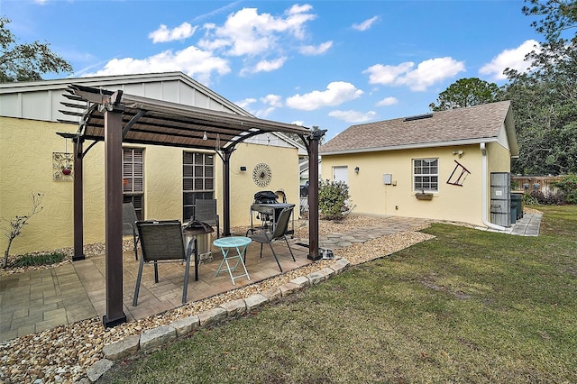 rear view of house with a yard, a pergola, and a patio