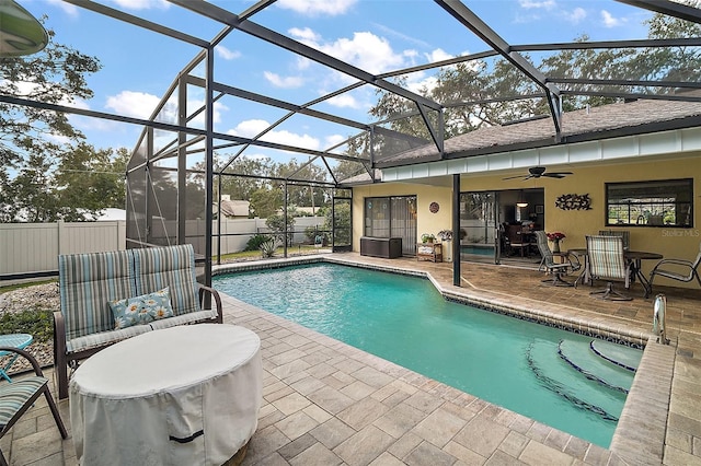 view of pool featuring ceiling fan, a lanai, and a patio