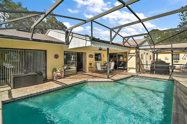 view of pool featuring a lanai, a patio area, and ceiling fan