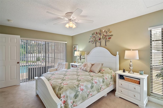 carpeted bedroom featuring ceiling fan, a textured ceiling, and access to outside