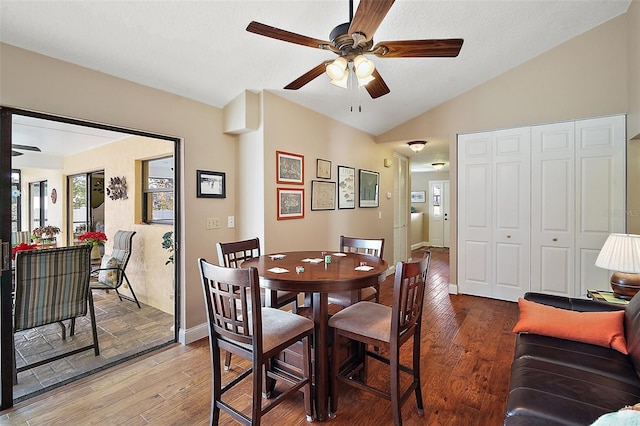 dining room featuring ceiling fan, hardwood / wood-style floors, and lofted ceiling