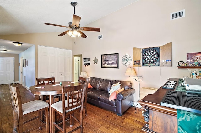 dining room with hardwood / wood-style floors, ceiling fan, and vaulted ceiling