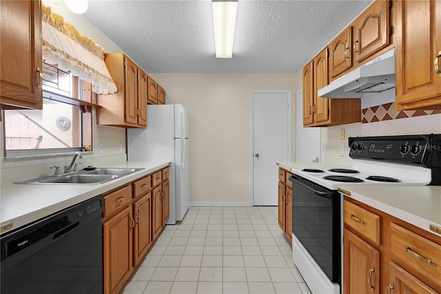 kitchen with a textured ceiling, white appliances, and sink