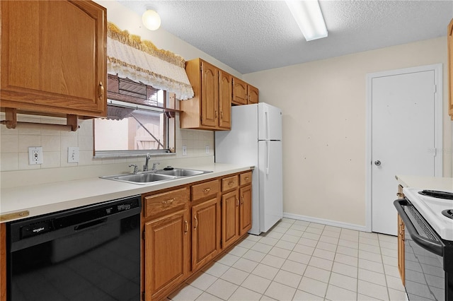 kitchen with a textured ceiling, backsplash, white appliances, and sink