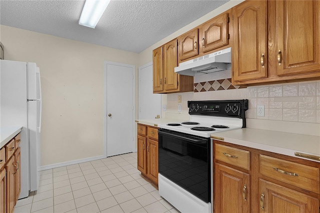 kitchen with a textured ceiling, white appliances, tasteful backsplash, and light tile patterned flooring